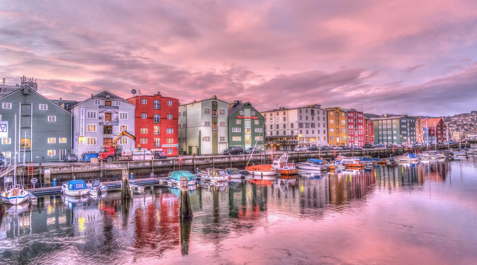 reflection of buildings in water at sunset