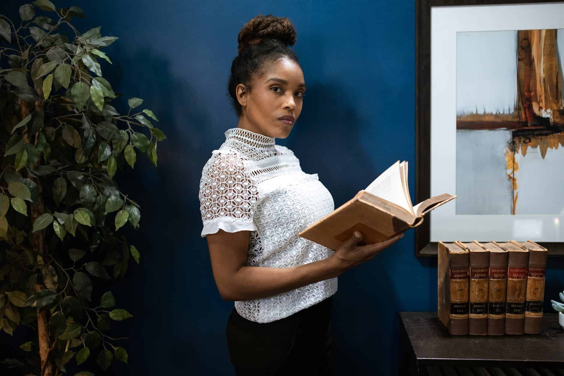 a woman reading books by robert kiyosaki
